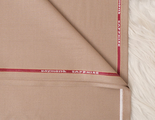 Close-up of beige fabric with 'Raymond Sapphire' branding.
